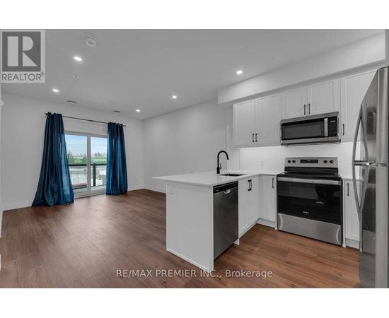 A modern kitchen with white cabinets and stainless steel appliances.