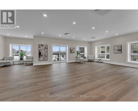 A spacious room with wooden floors and white walls, furnished with a sofa set and a coffee table.