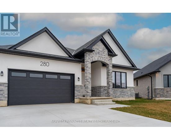 A modern house with a stone pillar entrance and a garage door.