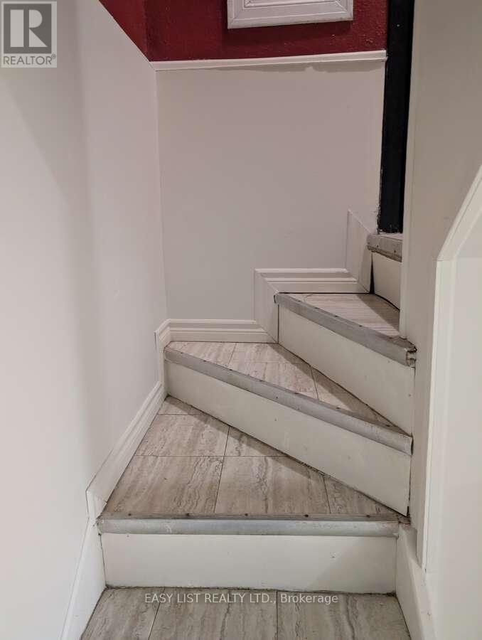 A staircase with a red wall in the background.