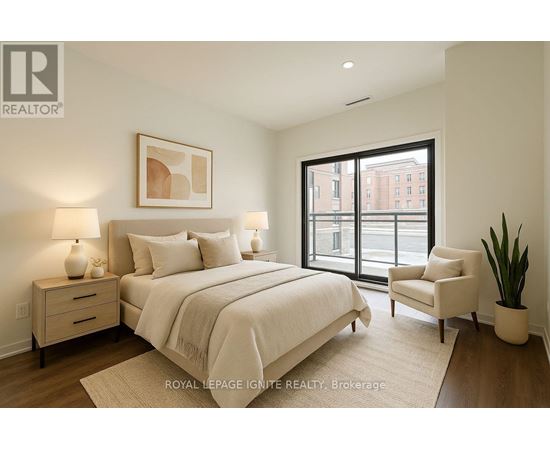 A bedroom with a large bed, a chair, and a plant.