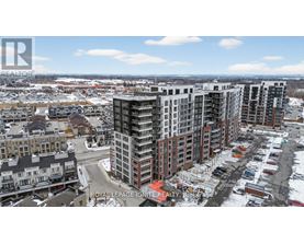 A cityscape with a mix of modern and older buildings, with a clear sky and some snow on the ground.