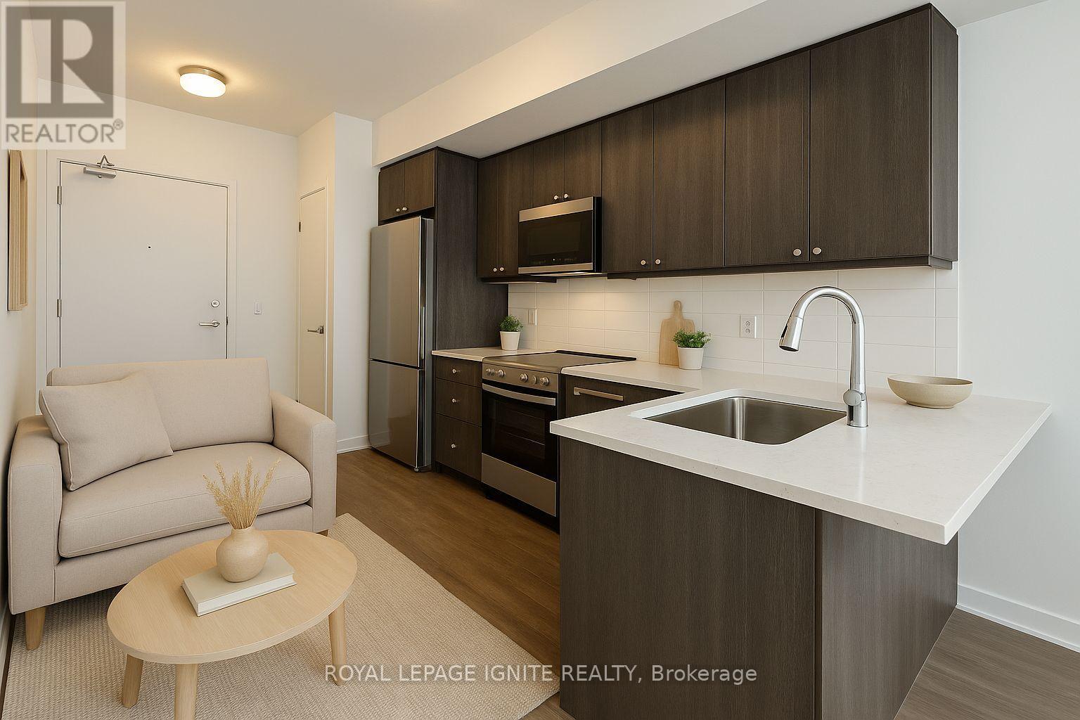 A modern kitchen with a sink, refrigerator, and cabinets.