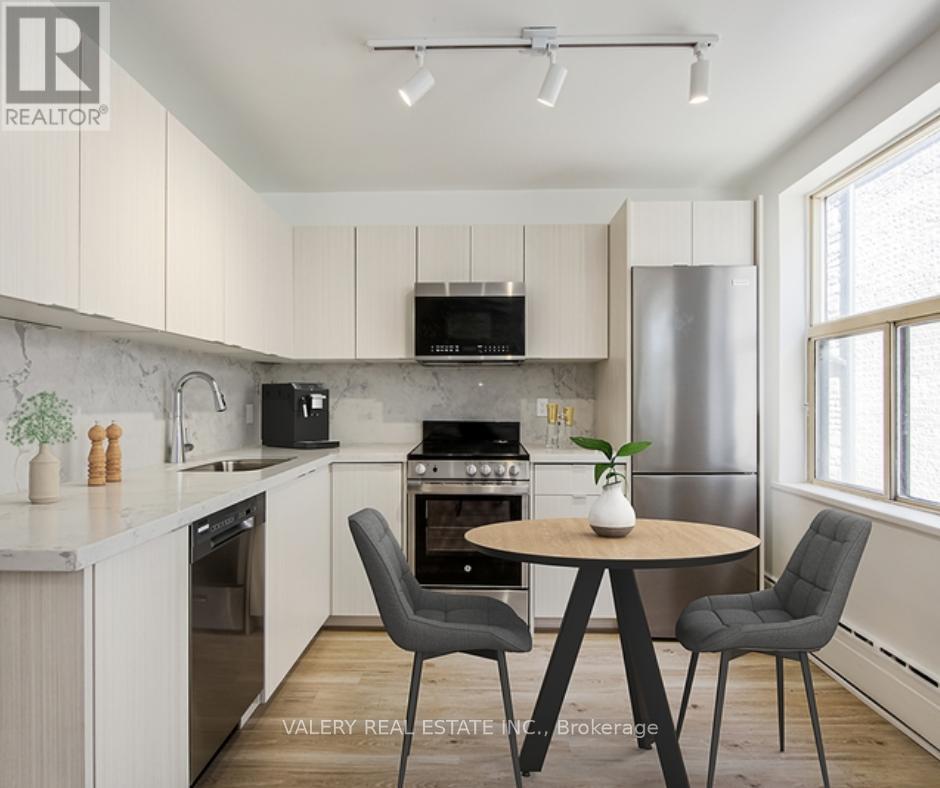 A modern kitchen with a round table and chairs.