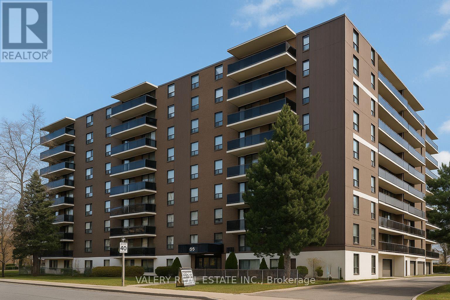 A tall apartment building with a sign that says "Valley R Estate Inc Brokerage".