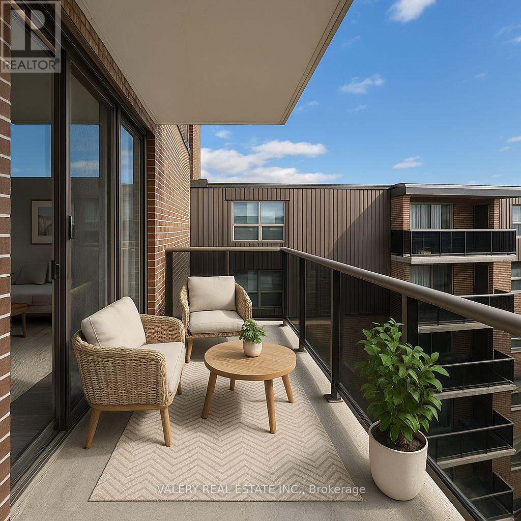 A balcony with a chair, table and potted plant.