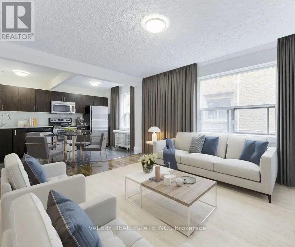 A modern living room with a white sofa and a glass coffee table.