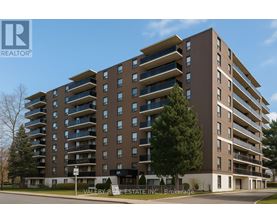 A tall apartment building with a sign that says "Valley R Estate Inc Brokerage".