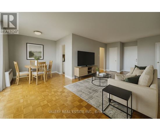 A living room with a couch, chairs, and a television.