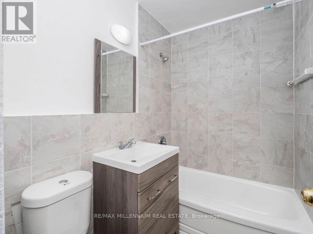 A bathroom with a toilet, sink, and bathtub.