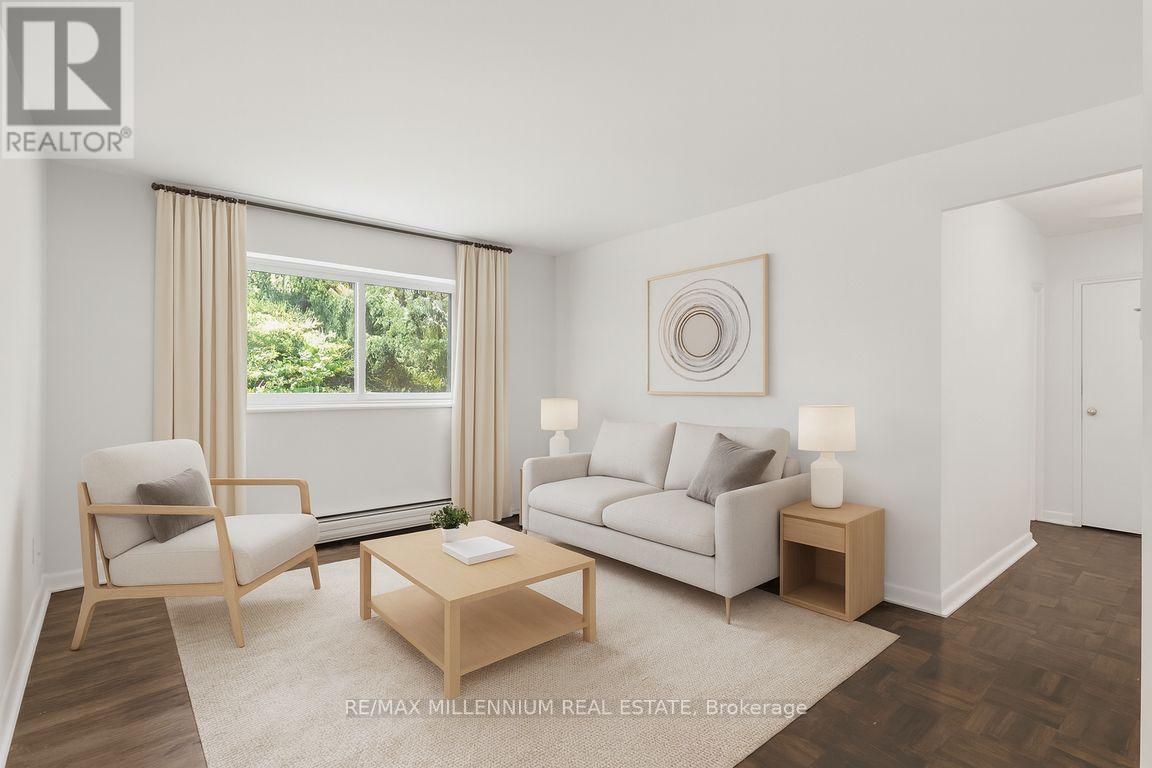 A well-lit, modern living room with a comfortable seating area and a large window.