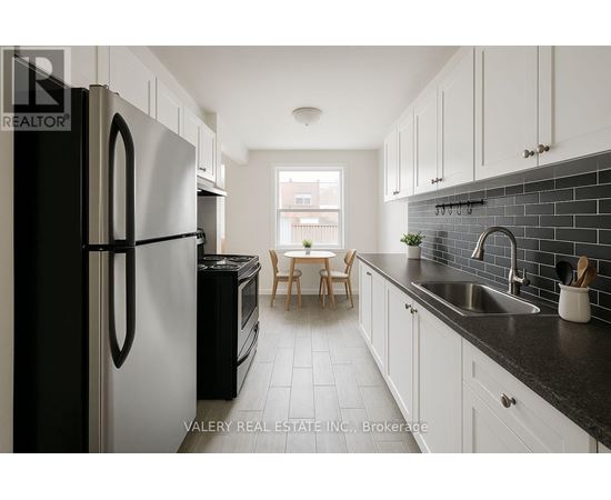 A kitchen with black and white appliances and cabinets.