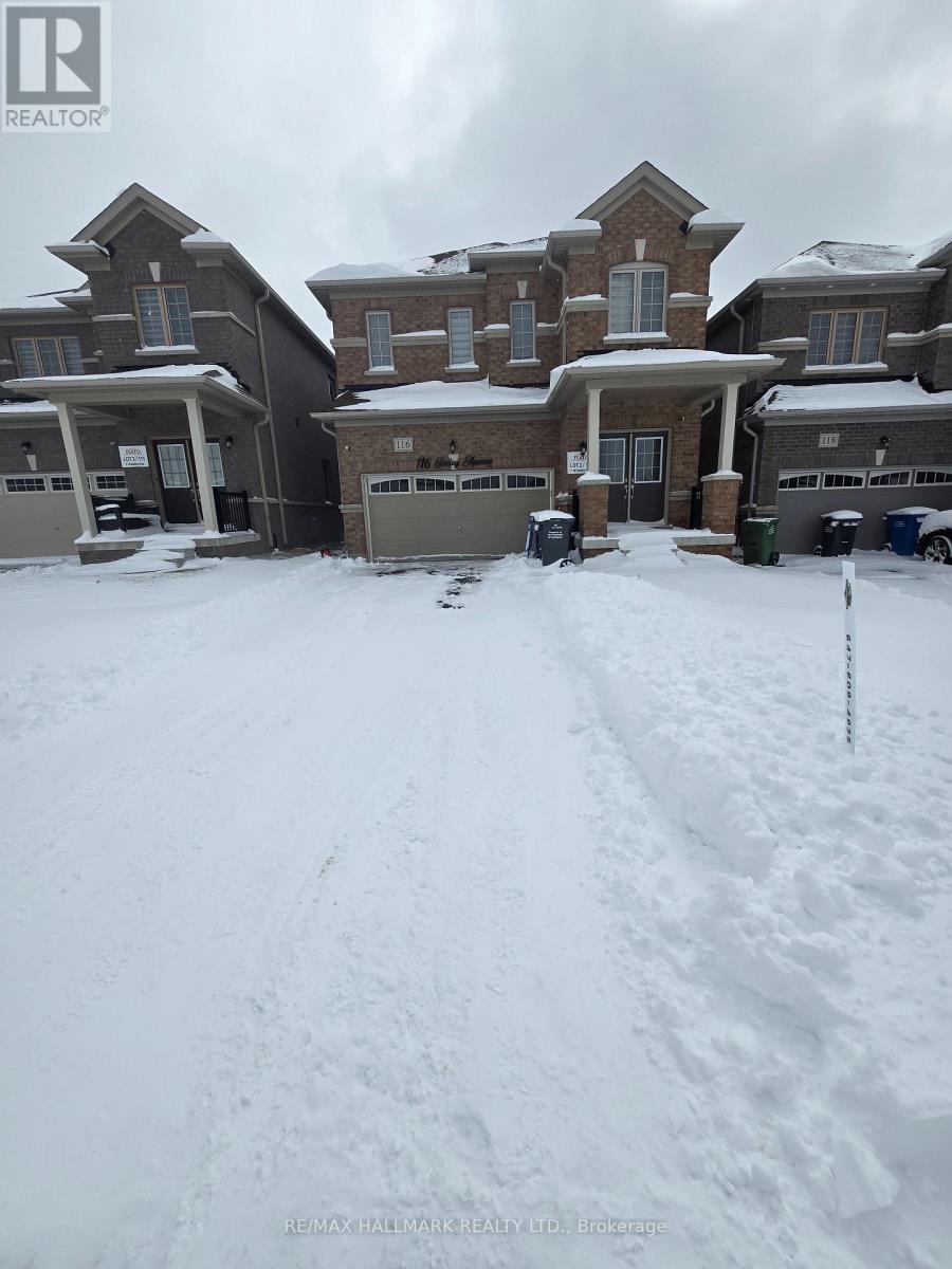 A snow-covered residential area with houses and a realtor logo.