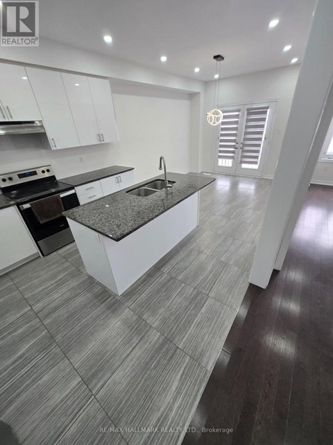 A modern kitchen with white cabinets and a central island.