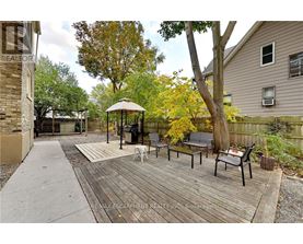 A gazebo sits in the middle of a wooden deck.