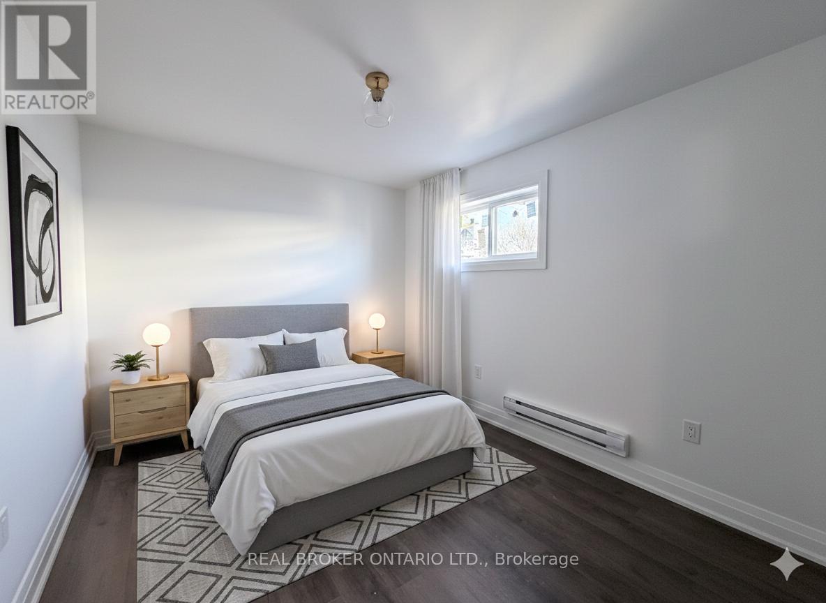 A bedroom with a large bed and two nightstands.