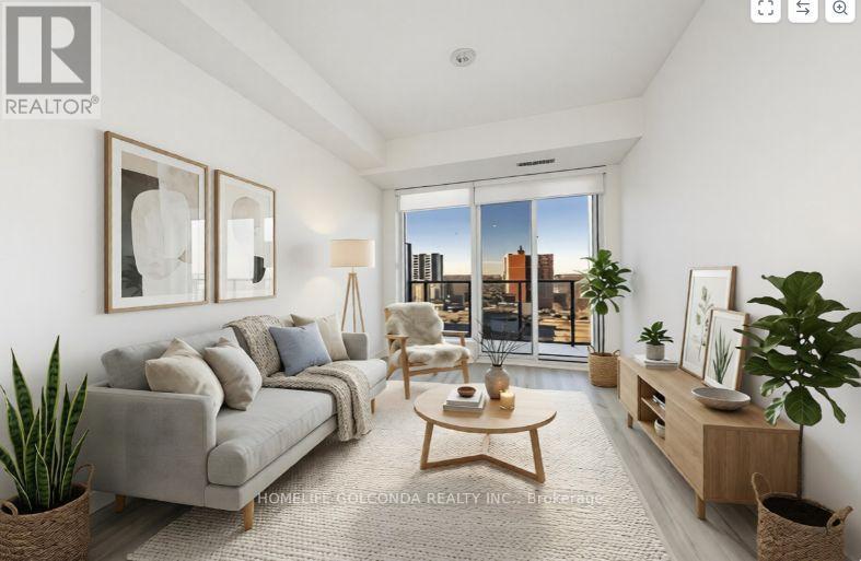 A well-lit living room with a grey sofa and a wooden coffee table.