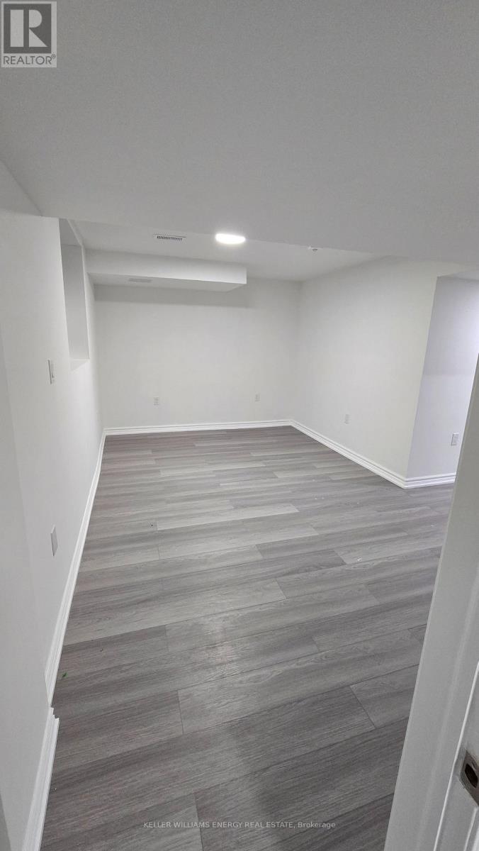 A spacious room with a grey floor and white walls.