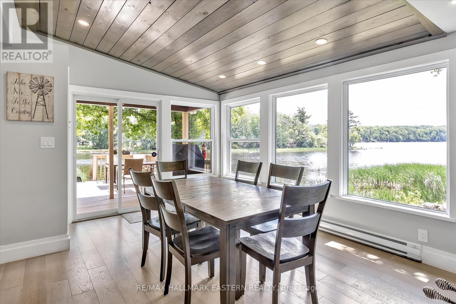 A dining room with a wooden table and chairs.