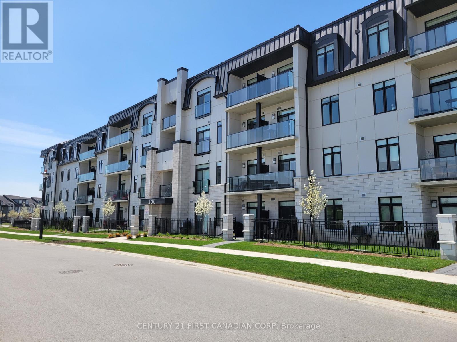 A modern apartment building with balconies and a sign that reads "REALTOR".