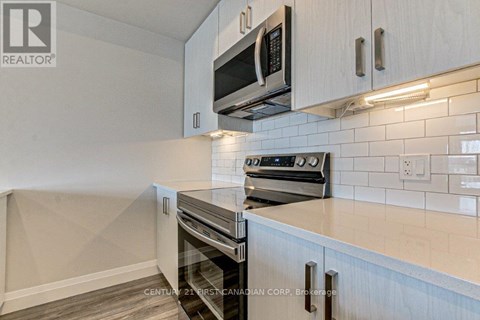 A kitchen with a stove top oven and microwave above it.