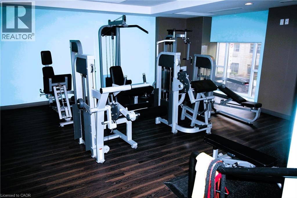 A gym with a variety of equipment including a leg press machine, a chest press machine, and a rowing machine.