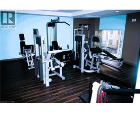 A gym with a variety of equipment including a leg press machine, a chest press machine, and a rowing machine.