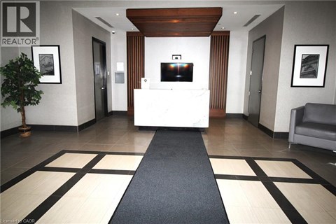 A modern living room with a black television and a blue chair.