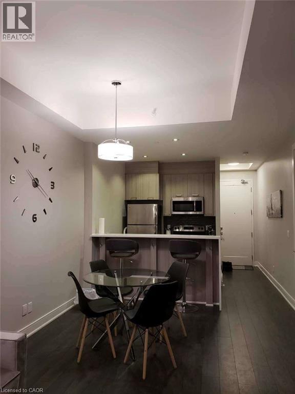 A modern kitchen with a dining table and chairs.