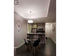 A modern kitchen with a dining table and chairs.