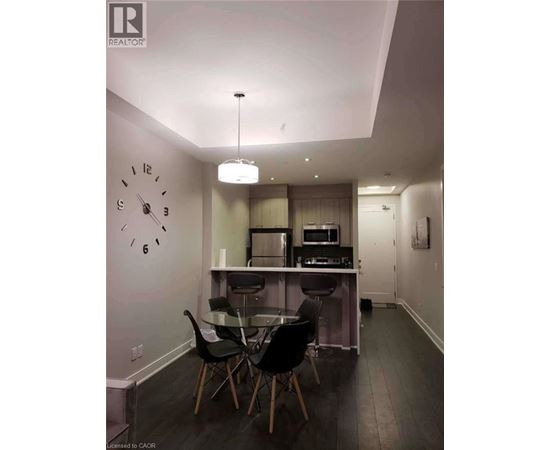 A modern kitchen with a dining table and chairs.