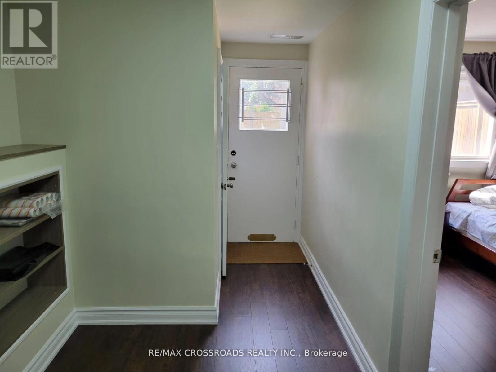 A hallway with a door and a window.