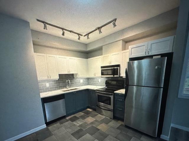 A kitchen with a checkered floor and a refrigerator on the right.