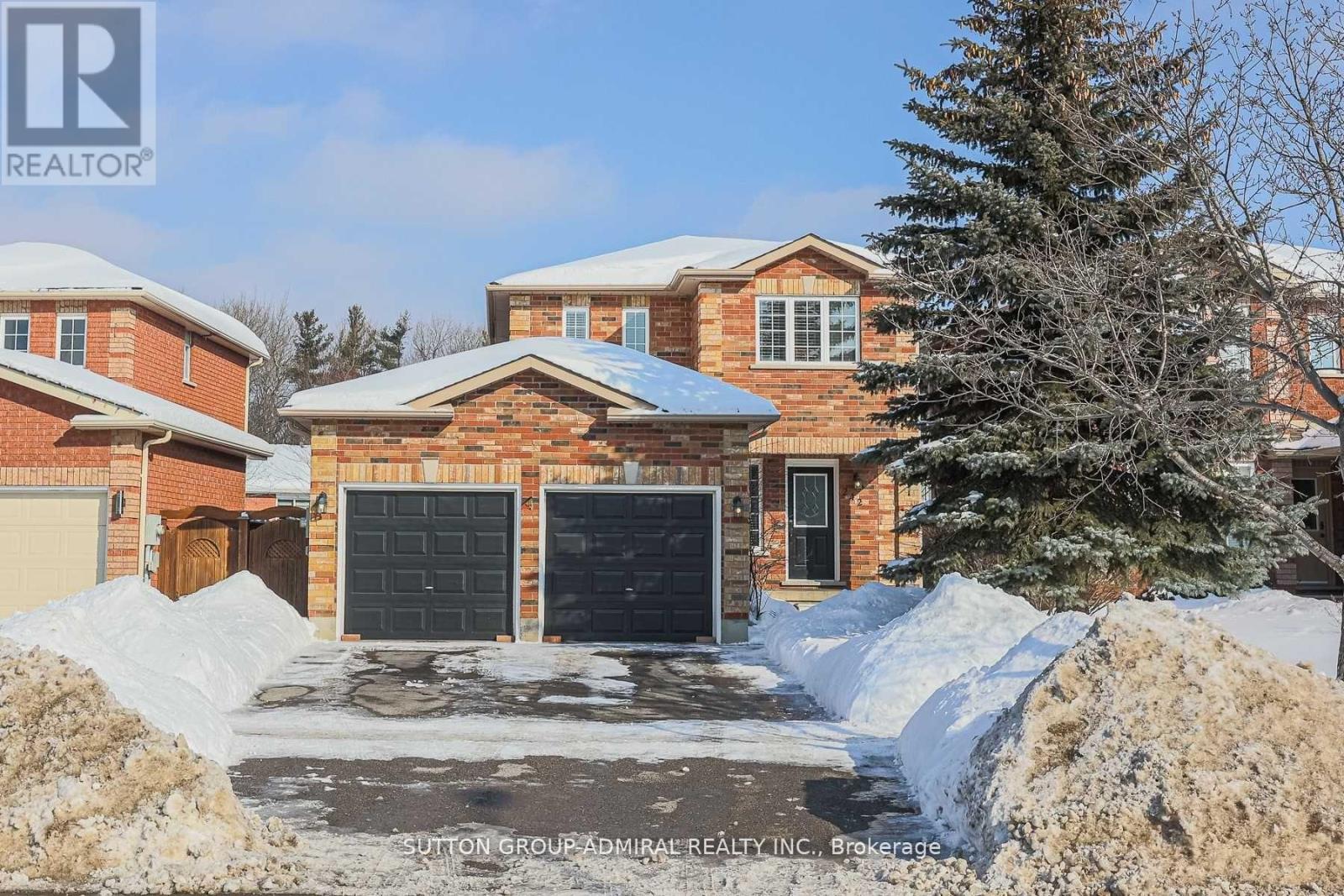 A house with a garage and a driveway covered in snow.