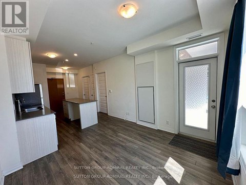 A living room with a television and a sliding glass door.