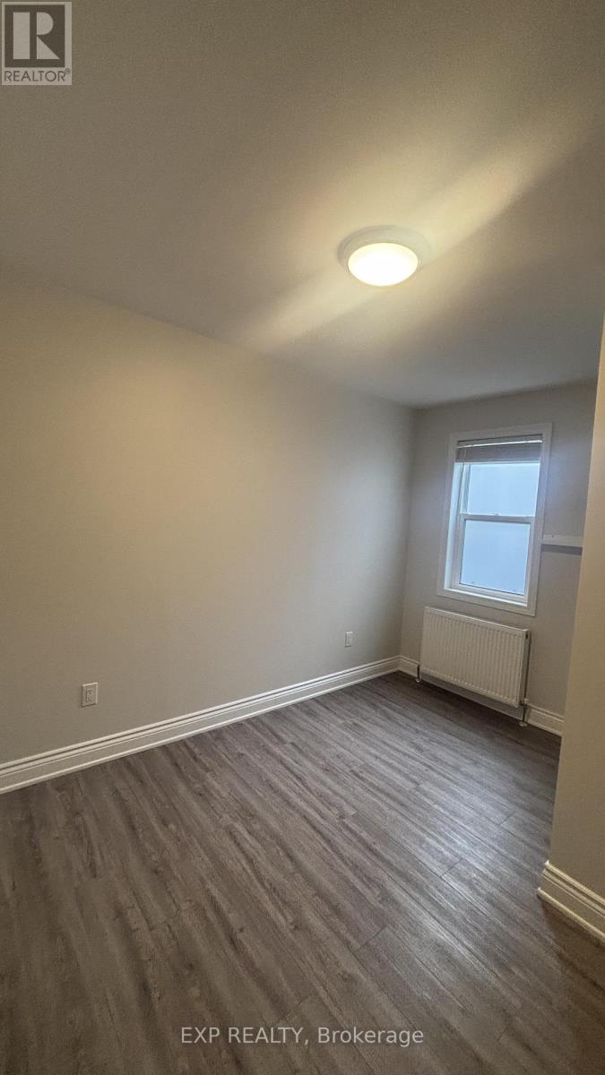 A room with a window and a radiator on the wall.