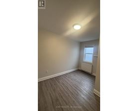A room with a window and a radiator on the wall.