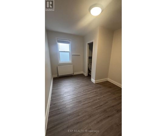 A room with a window and a radiator on the wall.