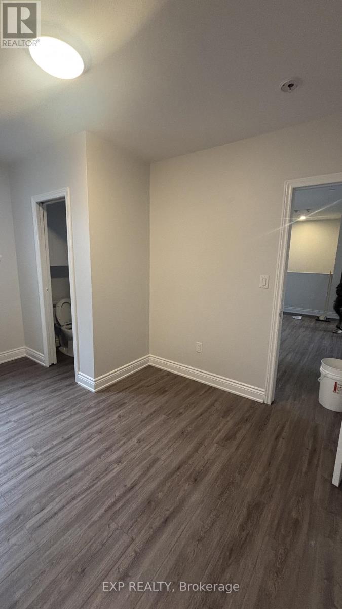 A room with wood flooring and white walls.