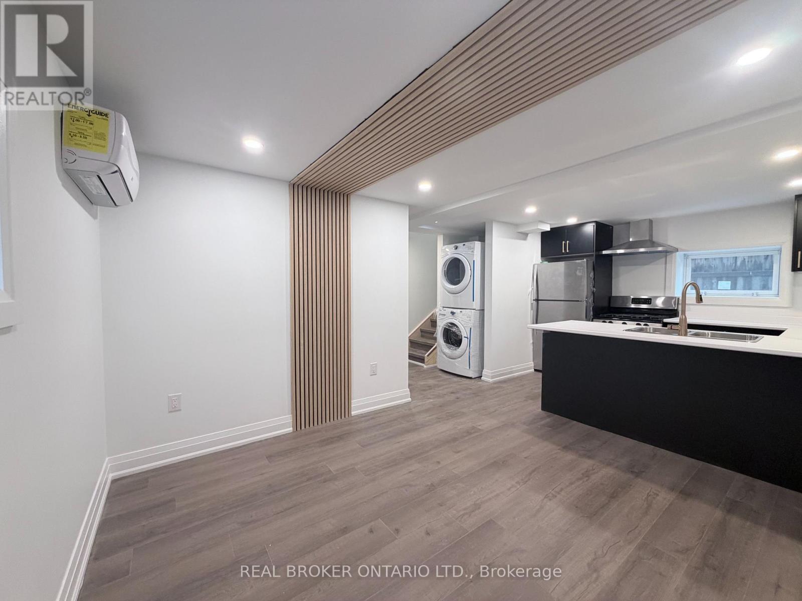 A modern kitchen with a washer and dryer built in.