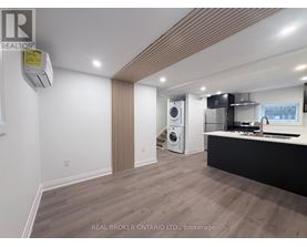 A modern kitchen with a washer and dryer built in.