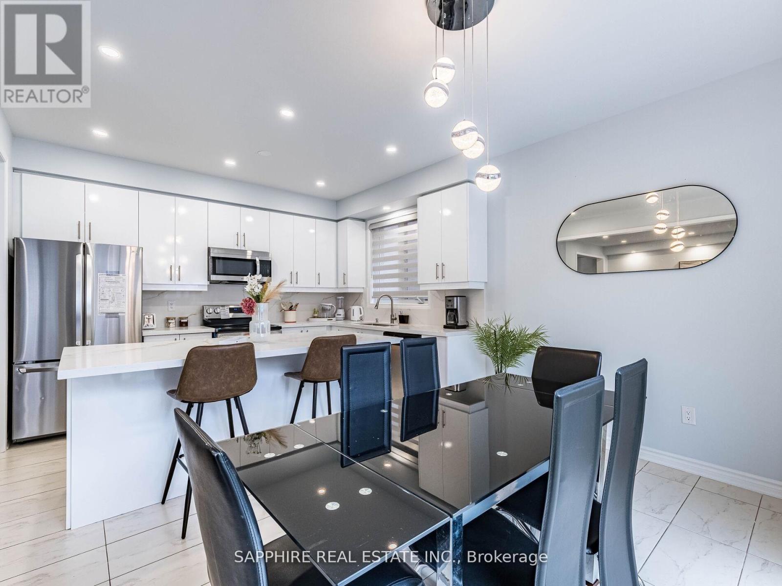 A modern kitchen with a dining table set for four.