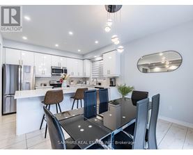 A modern kitchen with a dining table set for four.
