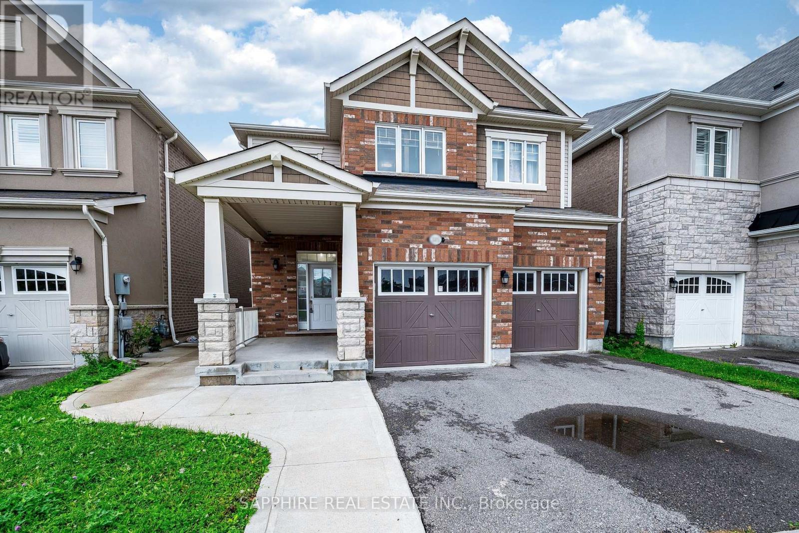 A house with a garage and a driveway in front.