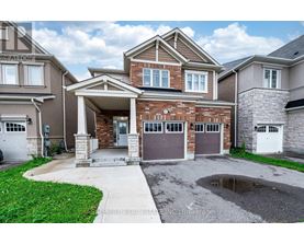 A house with a garage and a driveway in front.