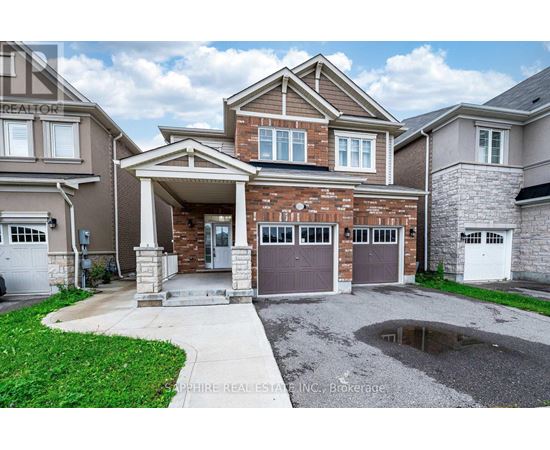 A house with a garage and a driveway in front.