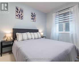 A bedroom with a large bed and two wall art pieces.