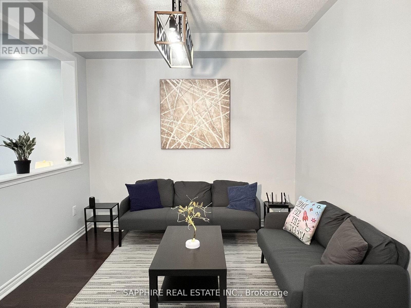 A living room with a grey couch and a brown coffee table.