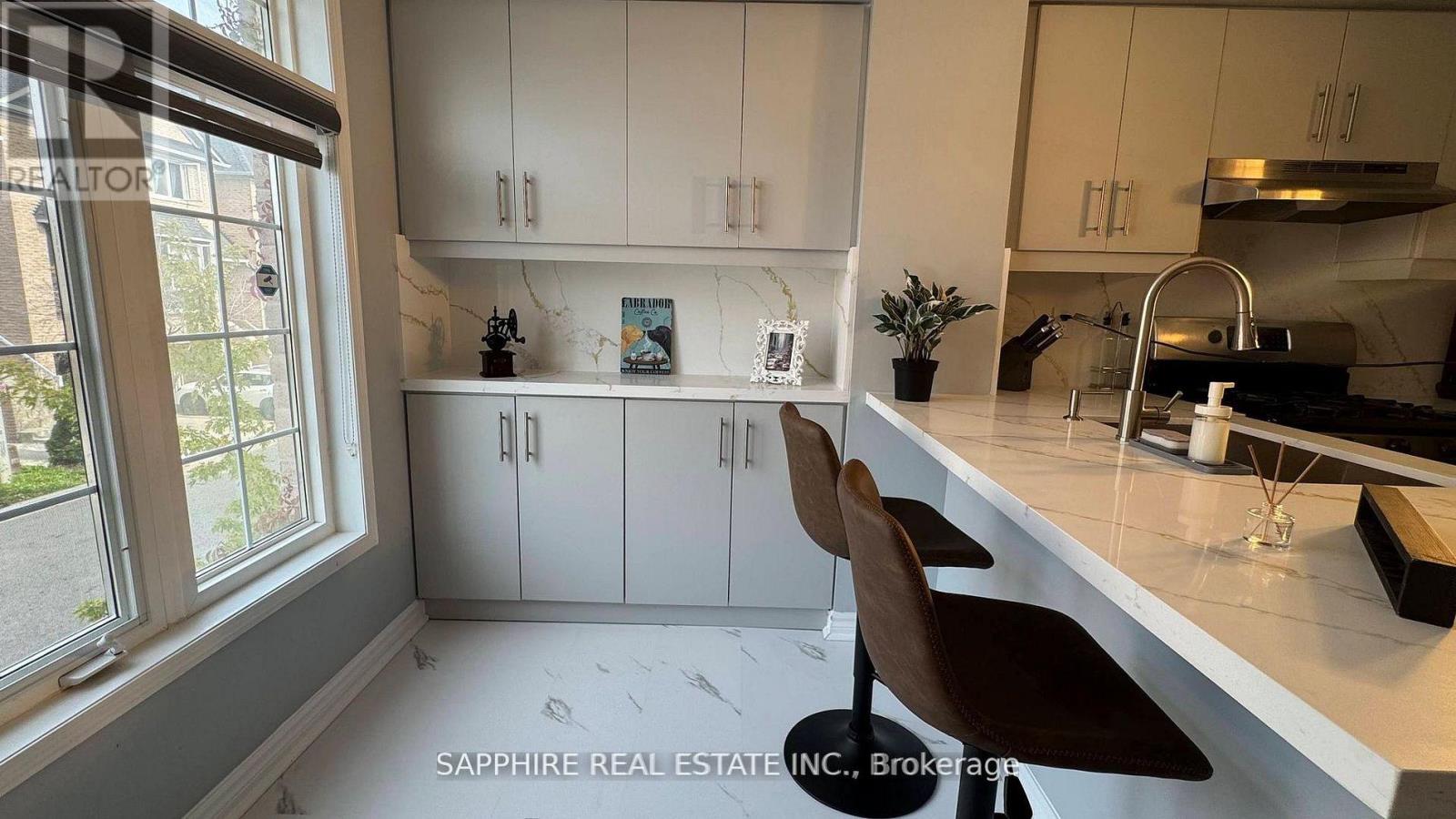 A modern kitchen with white cabinets and a large island.