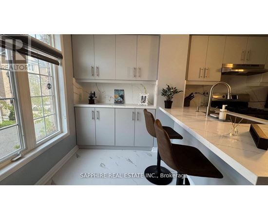 A modern kitchen with white cabinets and a large island.